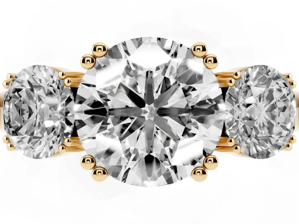 Three-Stone Round Cut Cut Diamond Ring with Channel Set Band and Four-Prong Setting Yellow gold