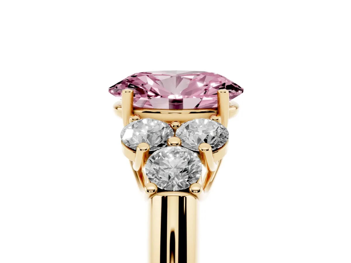Fancy Pink Oval Cut Cut Diamond Cluster Ring with Round Accent Stones and Prong Setting on a Classic Band Yellow gold
