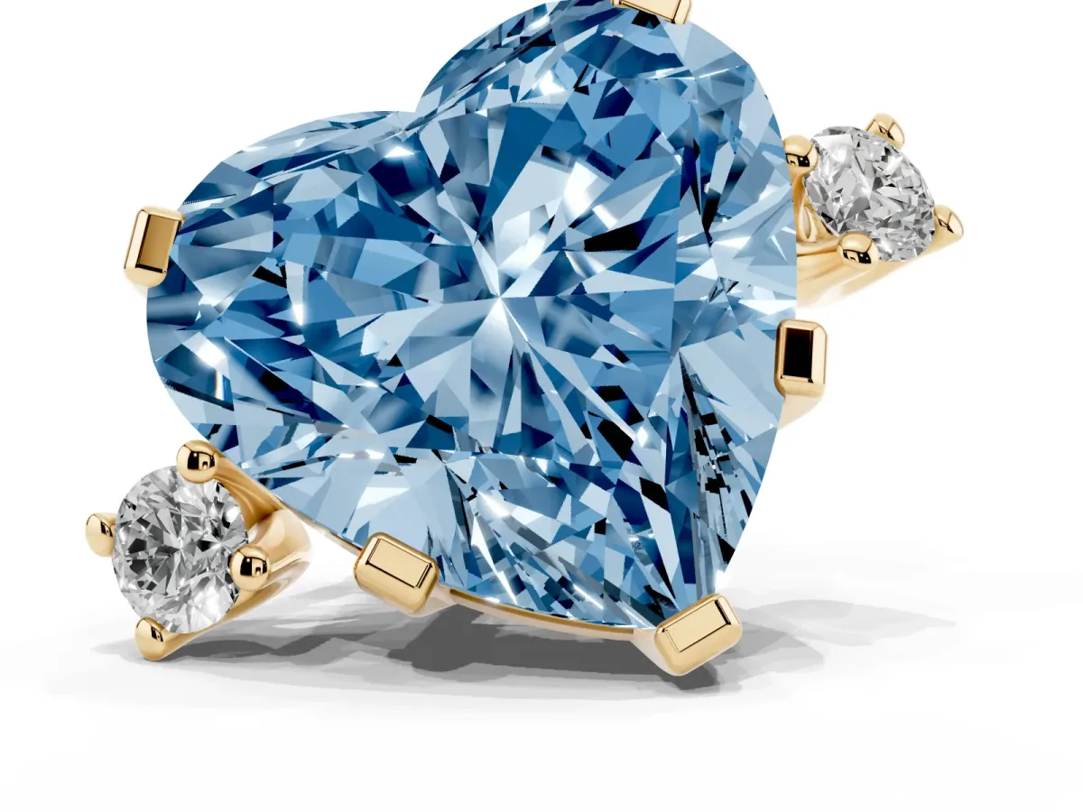 Fancy Blue Heart Cut Cut Three-Stone Solitaire Ring with Round Accent Diamonds and Four-Prong Setting Yellow gold
