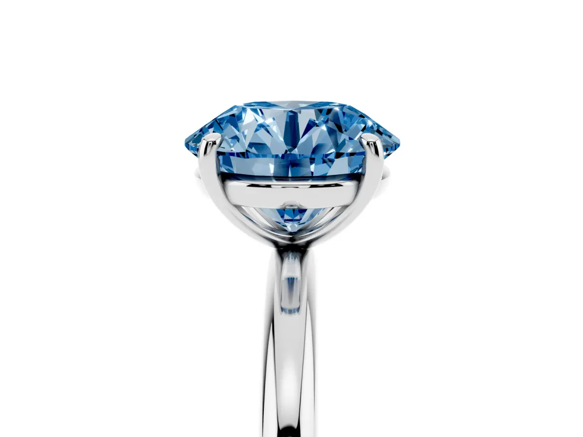 Fancy Blue Round Cut Solitaire Diamond Ring with Four-Prong Setting on a Plain Band Silver