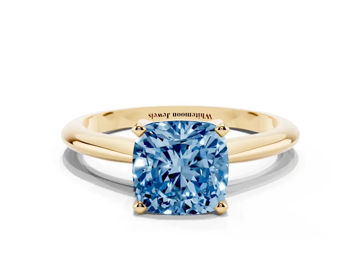 Fancy Blue Cushion Cut Cut Solitaire Ring with Four-Prong Setting on a Classic Band Yellow gold