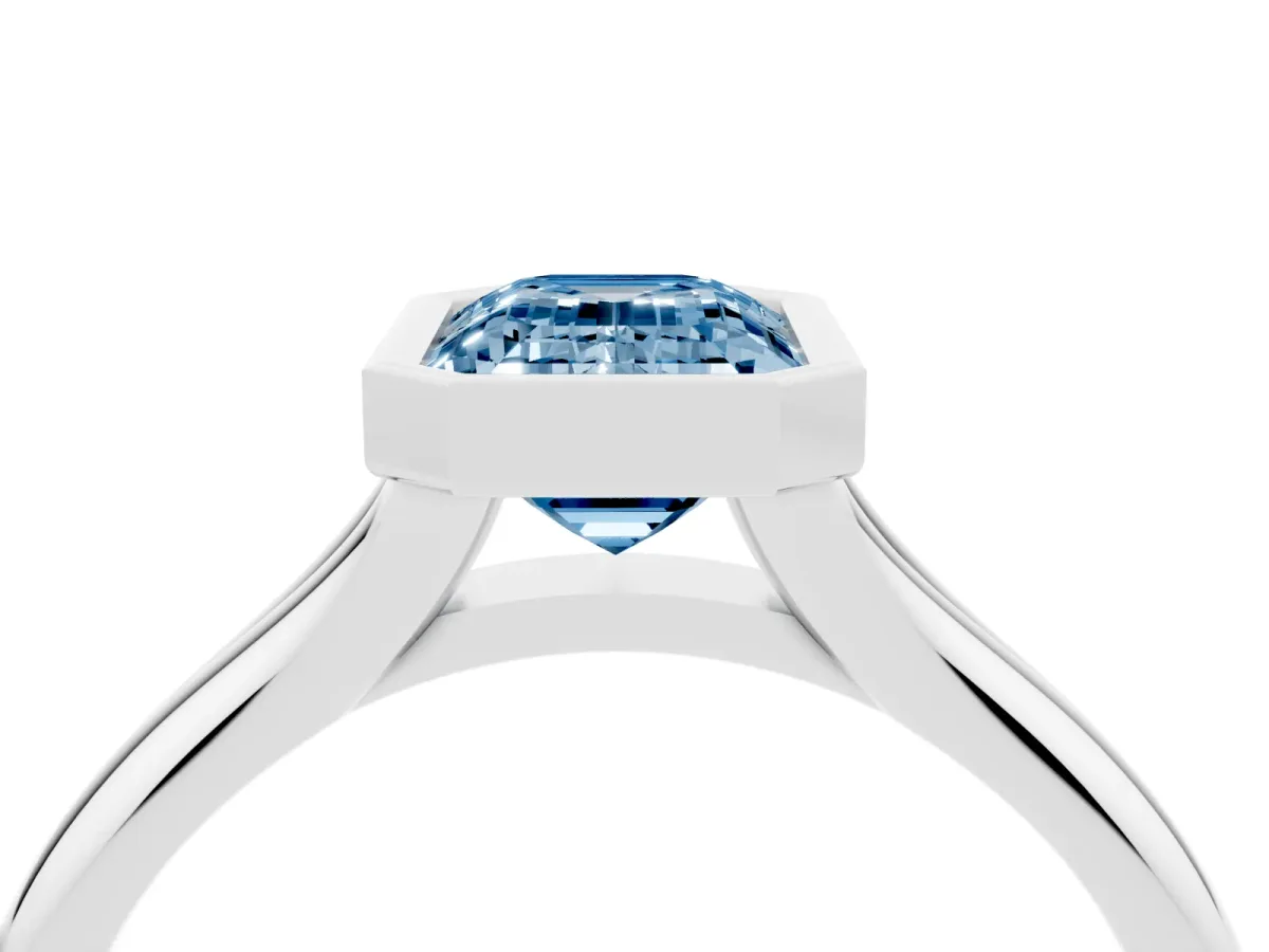 Fancy Blue Bezel Set Emerald Cut Solitaire Diamond Ring with Smooth Band Silver
