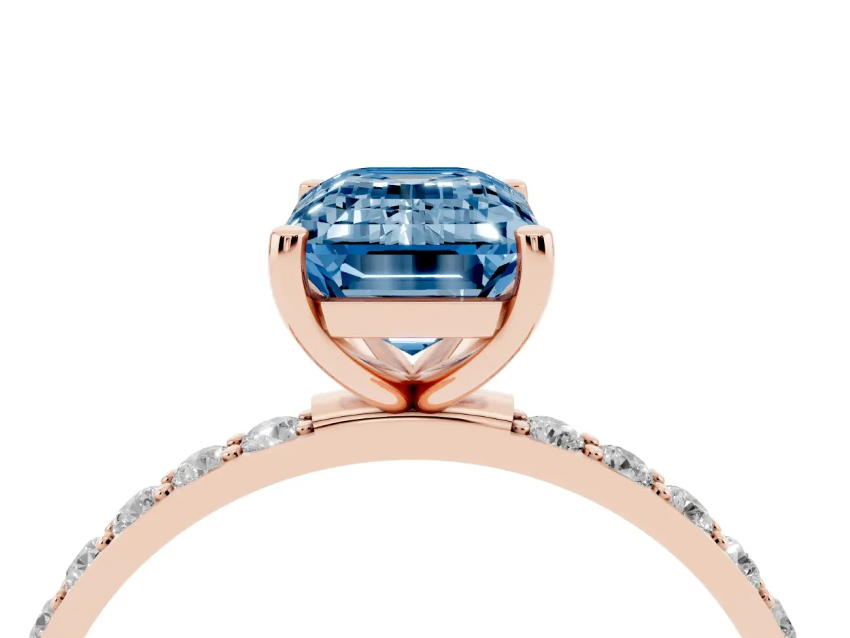 Fancy Blue Emerald Cut Diamond Solitaire Ring with Round Pavé Shoulders and Prong Setting Rose gold