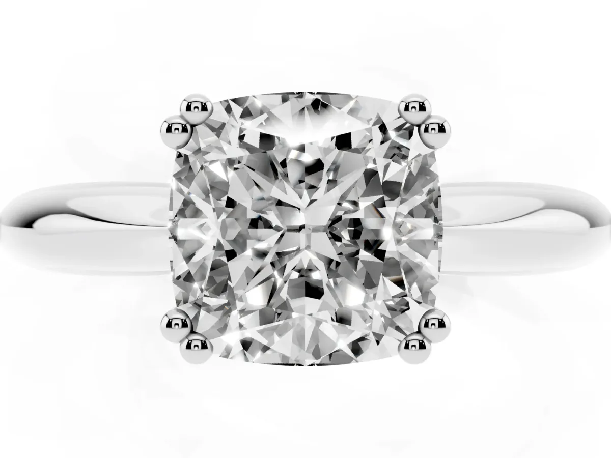 Cushion Cut Cut Solitaire Engagement Ring with Tapered Band and Four-Prong Setting Platinum