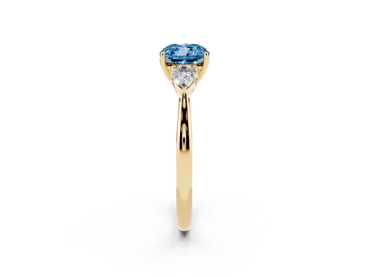 Fancy Blue Three-Stone Cushion Cut Diamond Ring with Pear Side Stones in Four-Prong Setting Yellow gold