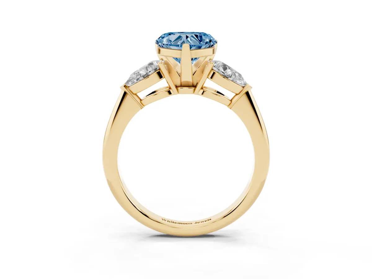 Fancy Blue Three-Stone Heart Cut Diamond Ring with Pear Side Stones and Four-Prong Setting Yellow gold