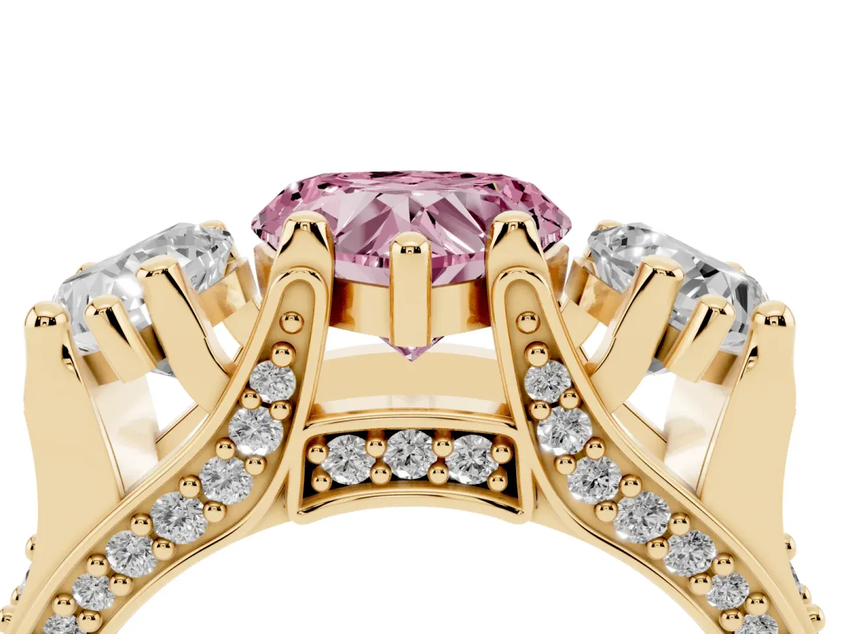 Fancy Pink Heart Cut Diamond Three-Stone Ring with Channel Set Band and Four-Prong Setting Yellow gold