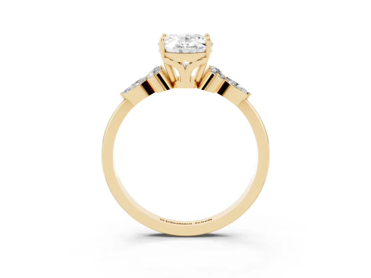 Oval Cut Brilliant Diamond Solitaire Ring with Pear Side Stones and Four-Prong Setting Yellow gold