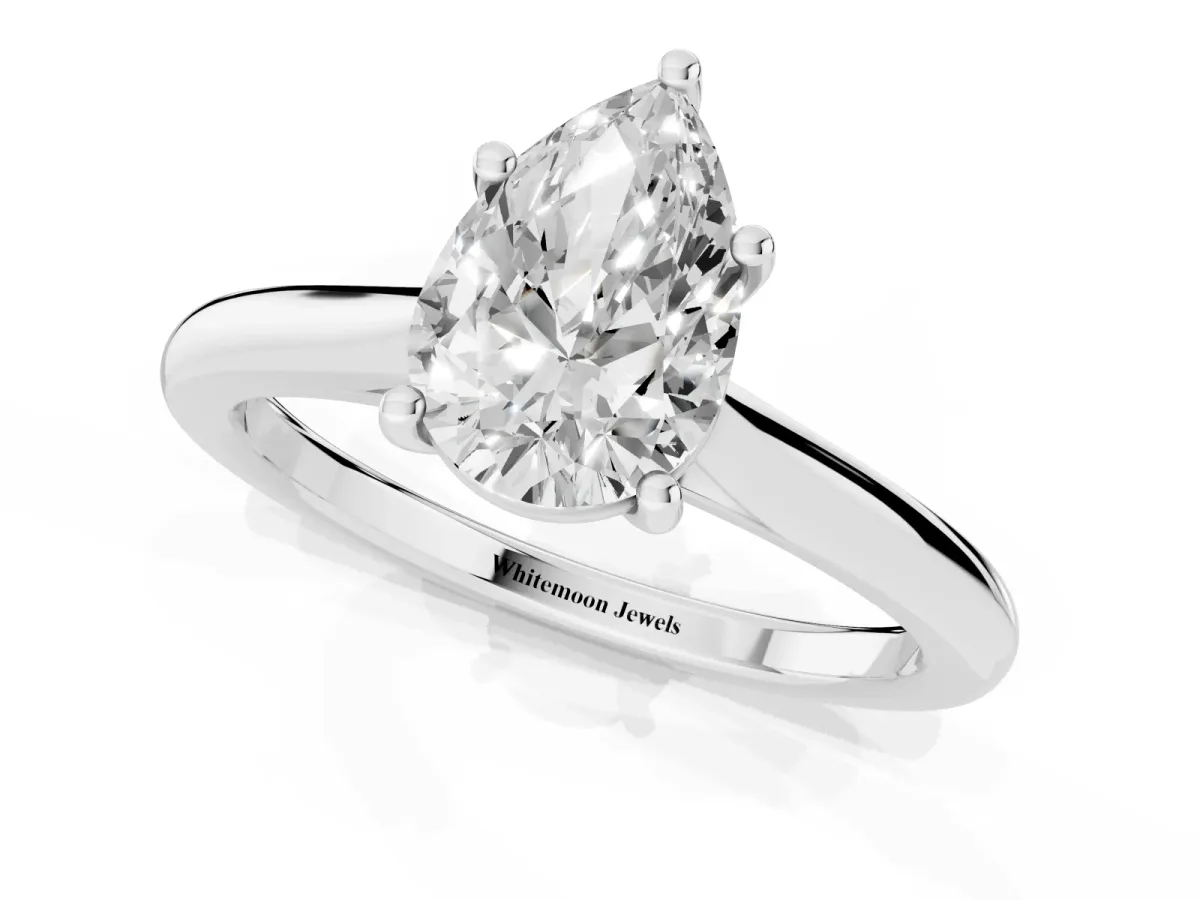 Pear Cut Cut Solitaire Ring with Cathedral Band and Four-Prong Setting Silver