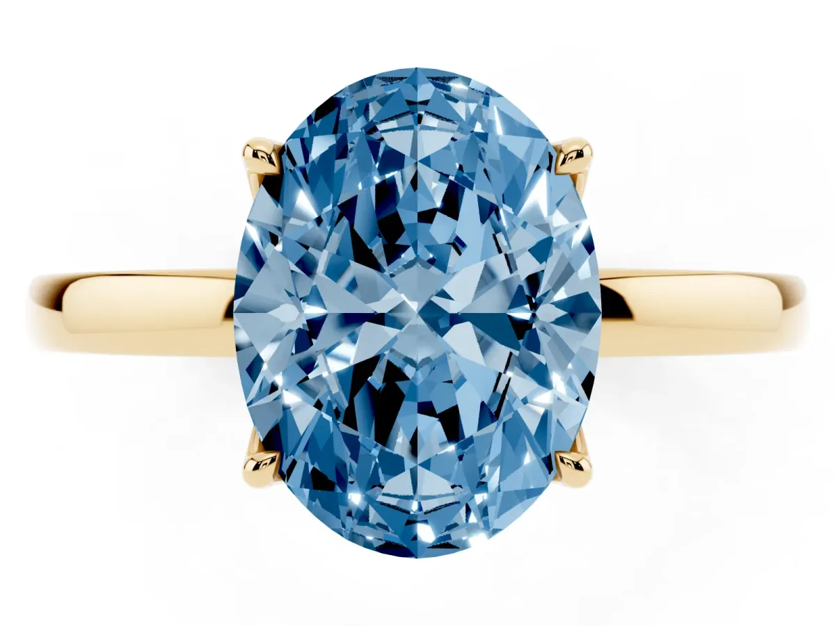 Fancy Blue Oval Cut Diamond Solitaire Ring with Thin Band and Prong Setting Yellow gold