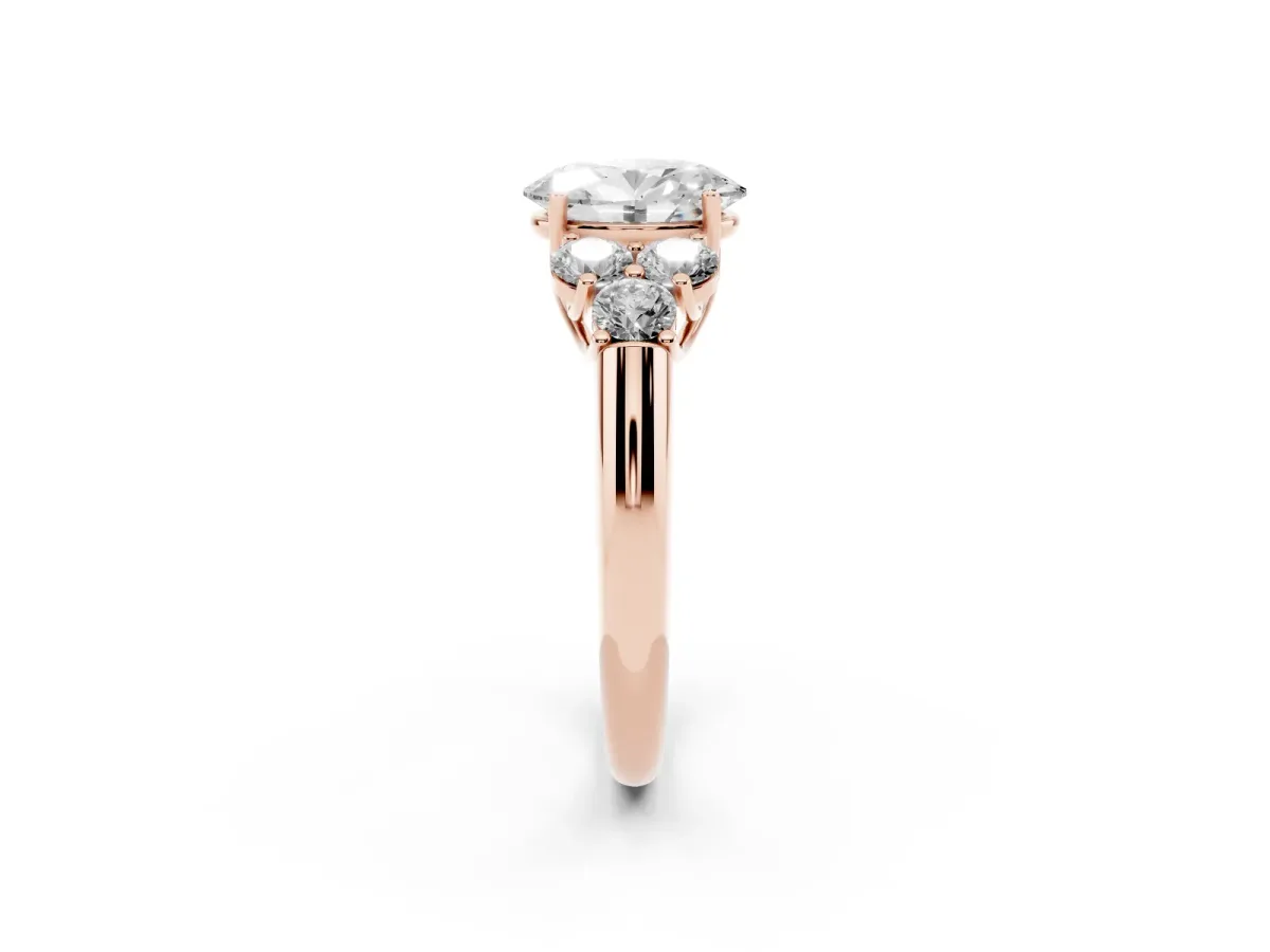 Oval Cut Cut Diamond Cluster Ring with Round Accent Stones and Prong Setting on a Classic Band Rose gold
