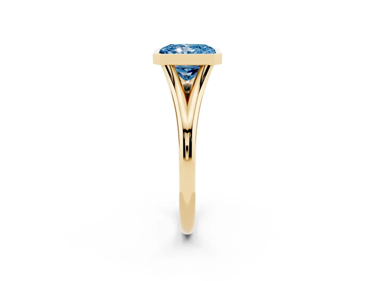 Fancy Blue Bezel Set Radiant Cut Cut Solitaire Ring with Tapered Band Yellow gold