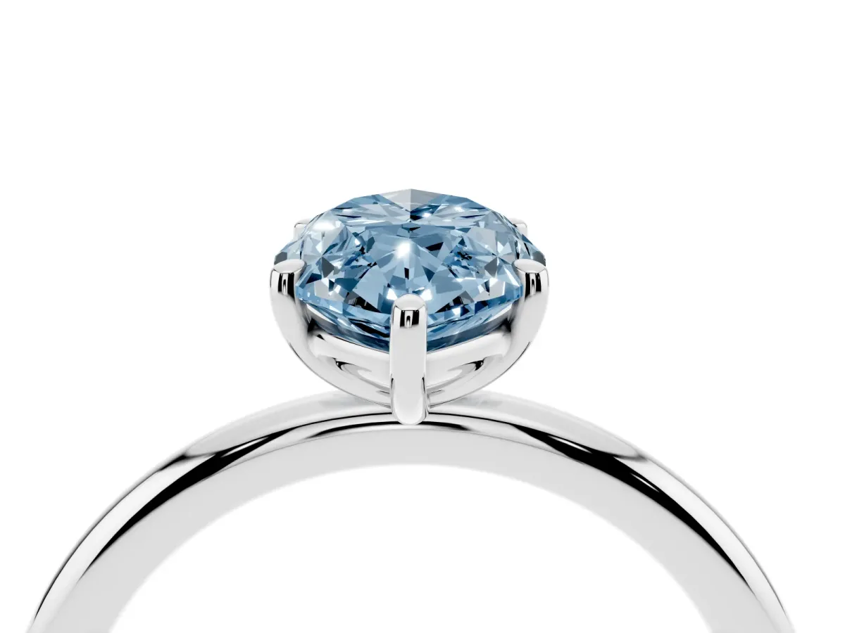 Fancy Blue Oval Cut Solitaire Diamond Ring with Four-Prong Setting on a Plain Band Platinum