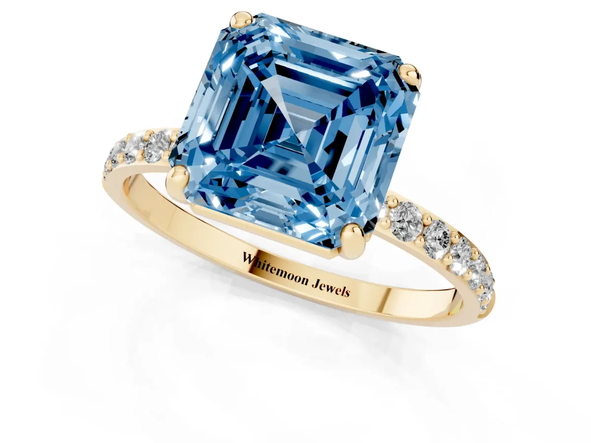 Fancy Blue Asscher Cut Diamond Solitaire Ring with Round Pavé Band and Prong Setting Yellow gold