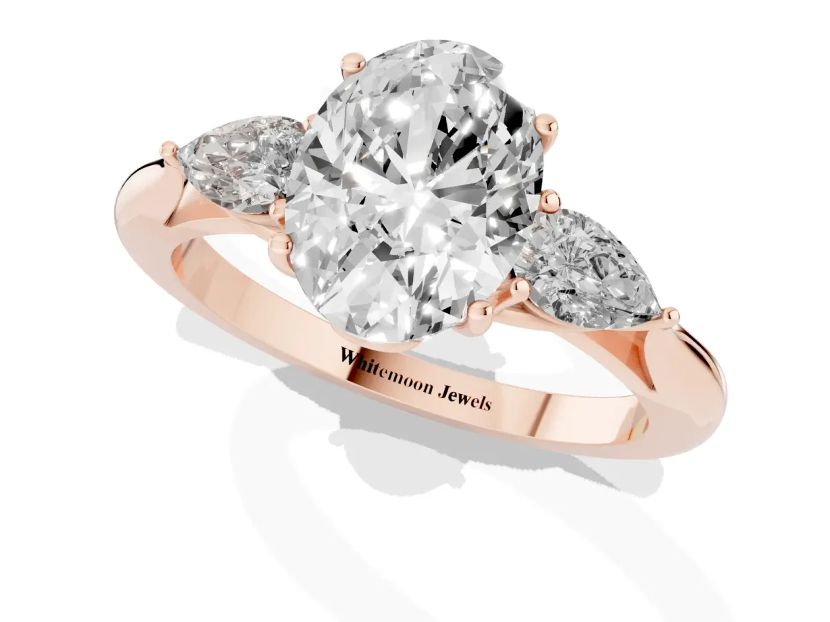 Three-Stone Oval Cut Diamond Ring with Pear Side Stones in Four-Prong Setting Rose gold