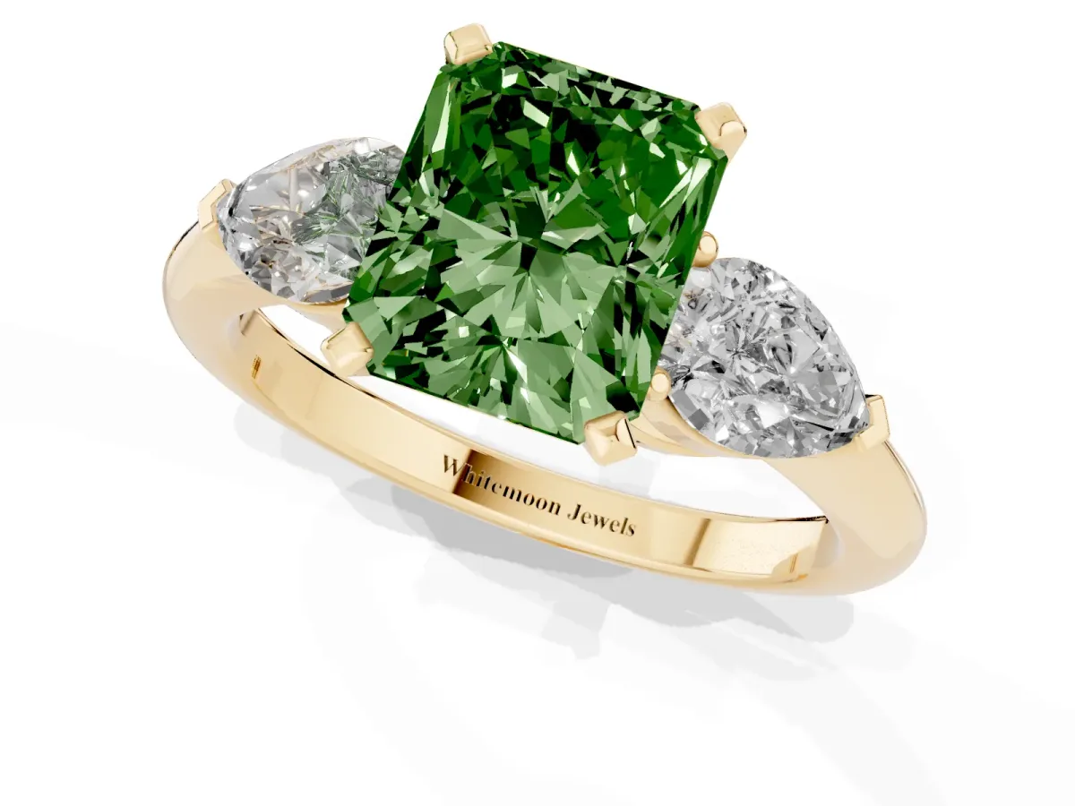 Fancy Green Three-Stone Radiant Cut Diamond Ring with Pear Side Stones and Four-Prong Setting Yellow gold