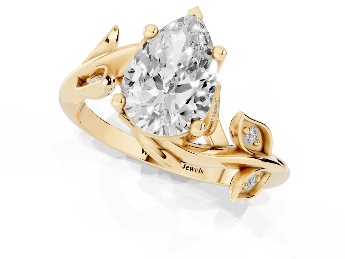Pear Cut Solitaire Twist Engagement Ring with Leaf Accents and Prong Setting Yellow gold