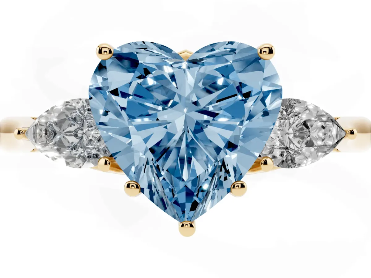 Fancy Blue Heart Cut Diamond Three-Stone Ring with Pear Side Stones and Prong Setting Yellow gold