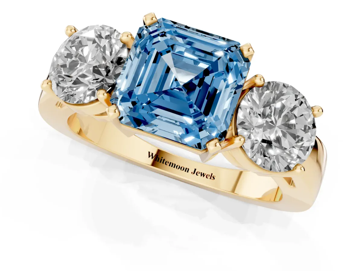 Fancy Blue Three-Stone Asscher Cut Diamond Ring with Round Side Stones, Classic Band, and Four-Prong Setting Yellow gold