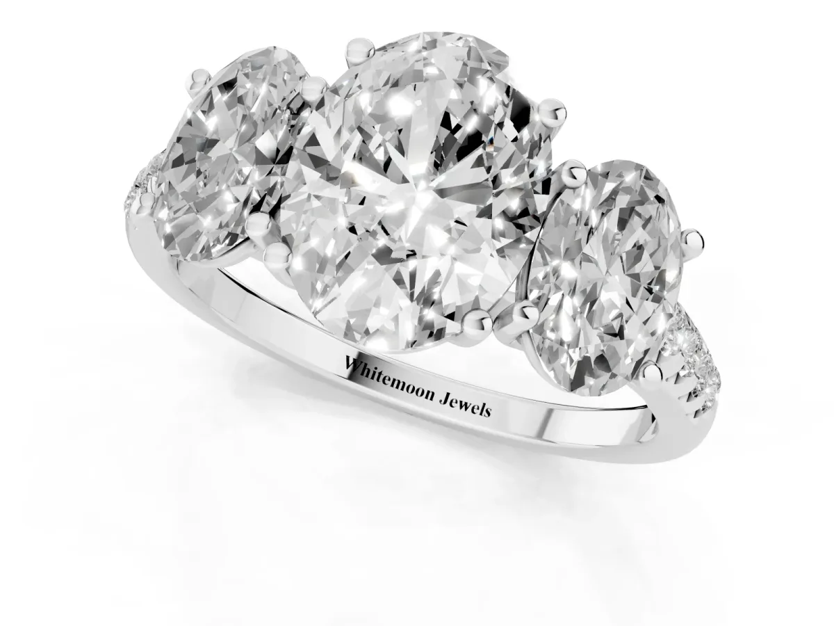 Three-Stone Oval Cut Diamond Ring with Round Pavé Band and Prong Setting Platinum