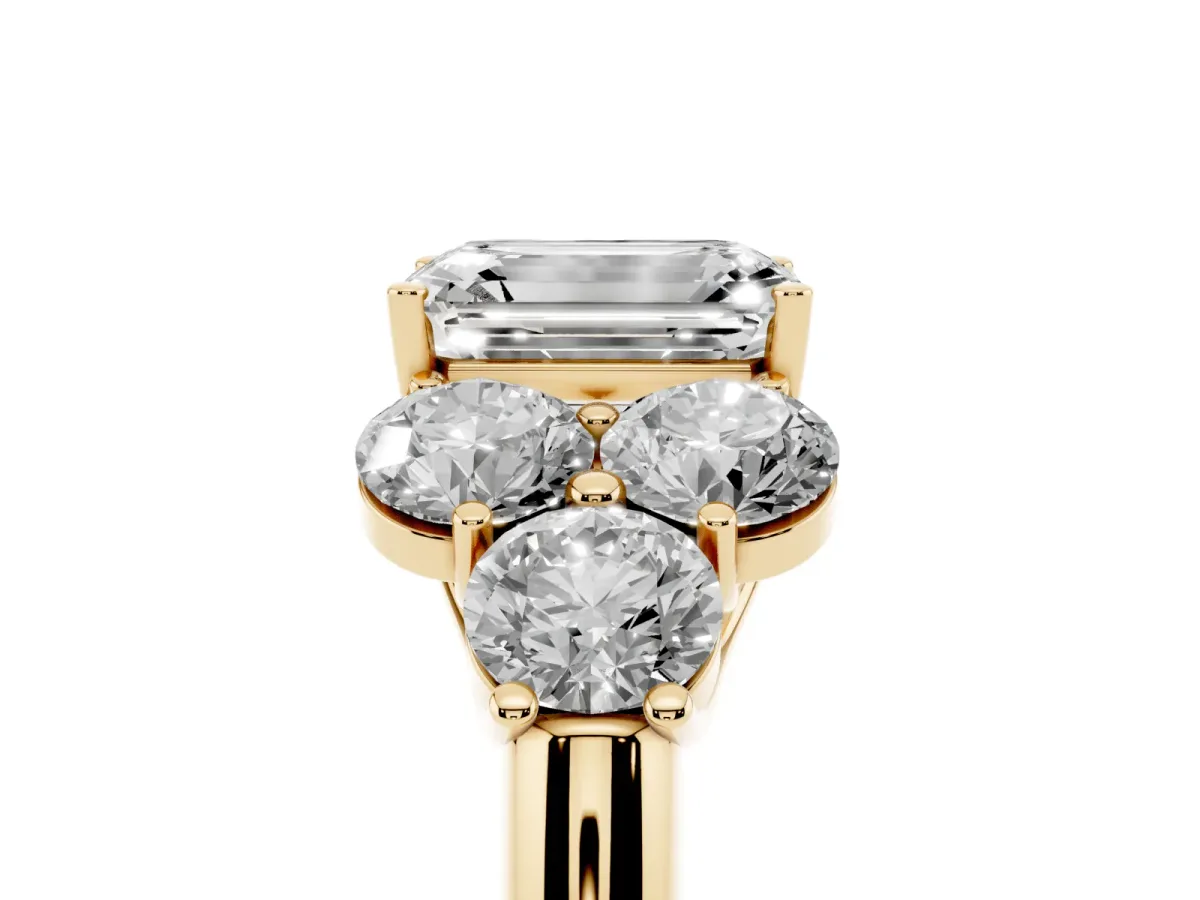 Emerald Cut Cut Diamond Cluster Ring with Round Accent Stones and Prong Setting on a Classic Band Yellow gold