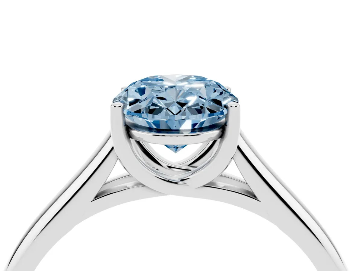 Fancy Blue Oval Cut Solitaire Engagement Ring with Tapered Band and Four-Prong Setting Silver