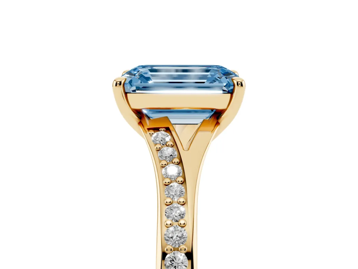 Fancy Blue Emerald Cut Diamond Solitaire Ring with Pavé Band and Prong Setting Yellow gold