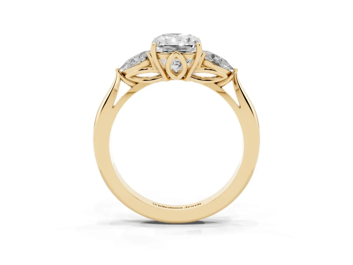 Three-Stone Radiant Cut Diamond Ring with Pear Side Stones in Four-Prong Setting Yellow gold
