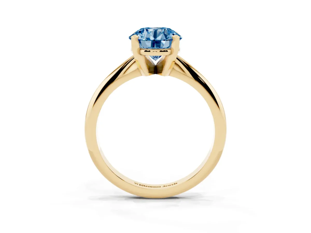Fancy Blue Round Cut Cut Solitaire Ring with Four-Prong Setting on a Classic Band Yellow gold