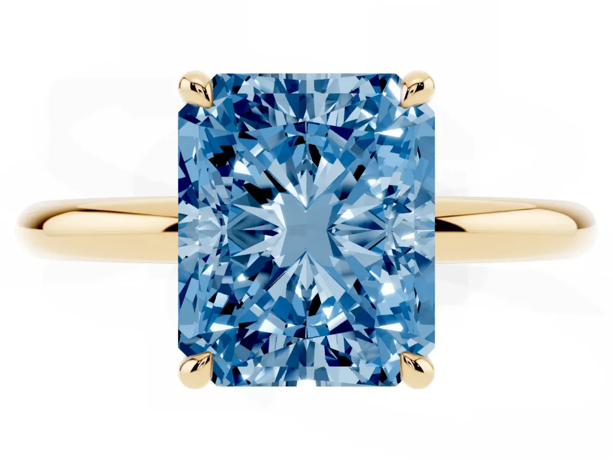 Fancy Blue Radiant Cut Diamond Solitaire Ring with Thin Band and Four-Prong Setting Yellow gold