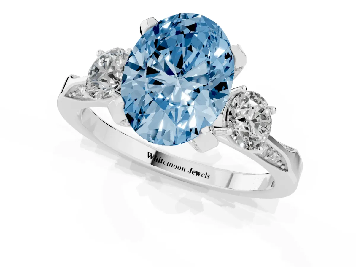 Fancy Blue Oval Cut Brilliant Three-Stone Diamond Ring with Pavé Band and Four-Prong Setting White gold