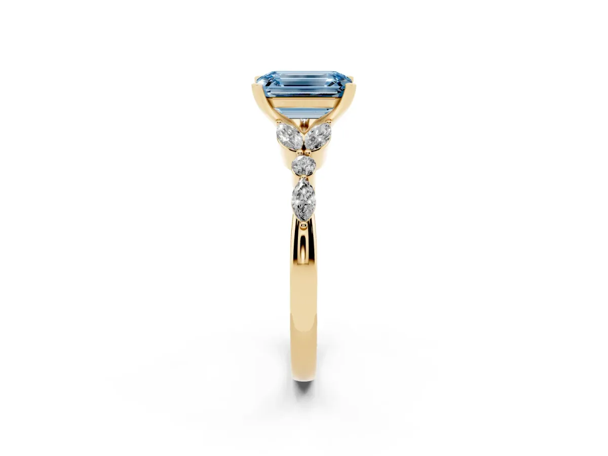 Fancy Blue Emerald Cut Diamond Solitaire Ring with Side Stones and Four-Prong Setting Yellow gold