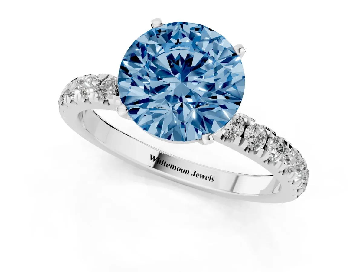 Fancy Blue Round Cut Diamond Solitaire Ring with Pavé Accents and Four-Prong Setting Platinum