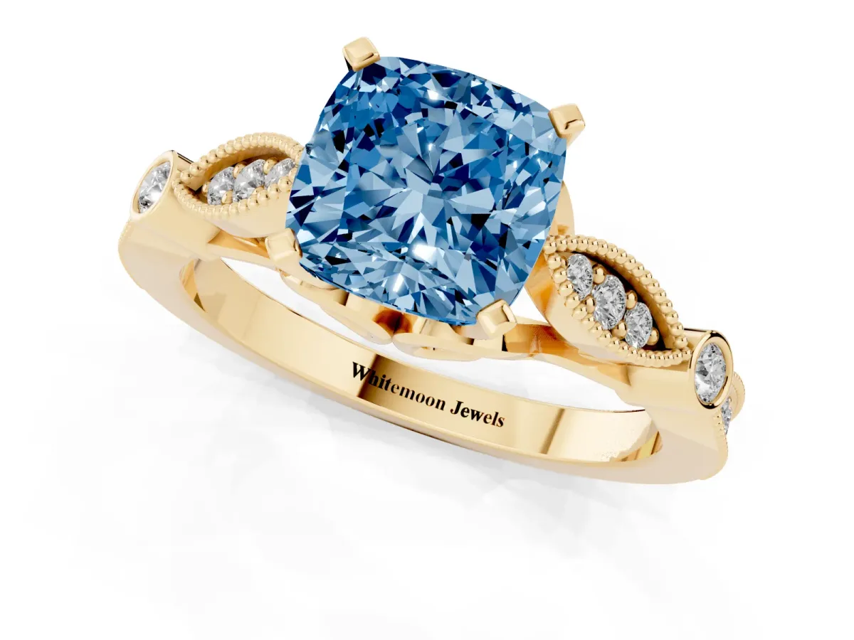Fancy Blue Cushion Cut Cut Diamond with Milgrain Marquise and Bezel Accents on a Solitaire Band with Prong Setting Yellow gold