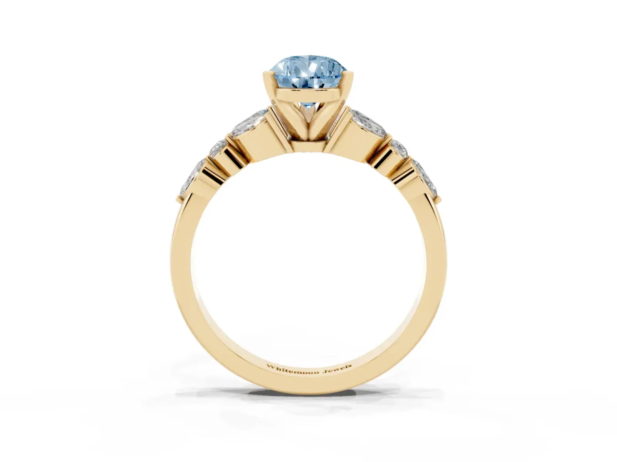 Fancy Blue Pear Cut Diamond Solitaire Ring with Side Stones and Four-Prong Setting Yellow gold