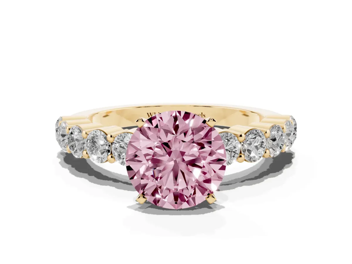 Fancy Pink Round Cut Diamond Solitaire Ring with Shared Prong Round Side Stones Yellow gold