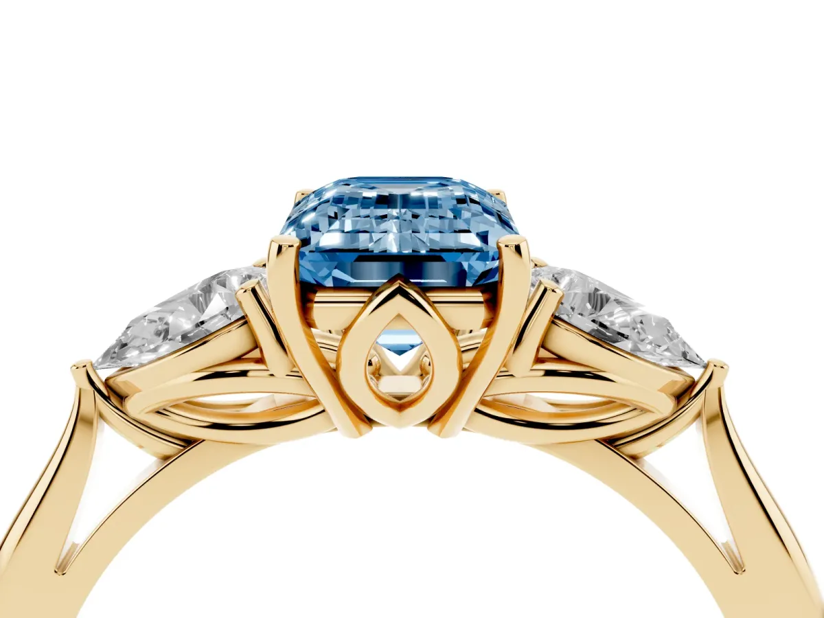 Fancy Blue Emerald Cut Diamond Three-Stone Ring with Pear Side Stones and Prong Setting Yellow gold