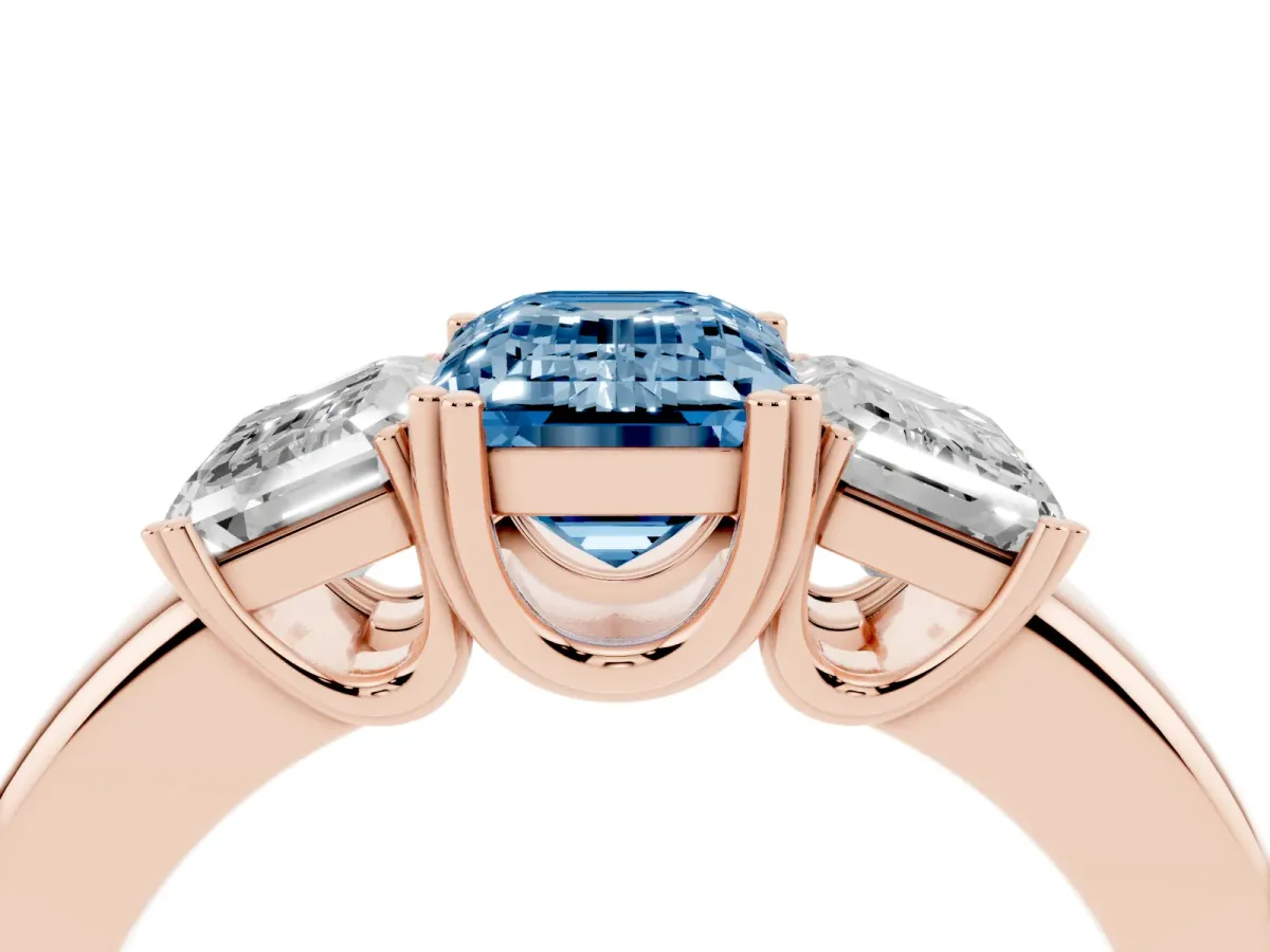 Fancy Blue Three-Stone Emerald Cut Cut Diamond Ring with Channel Set Band and Four-Prong Setting Rose gold
