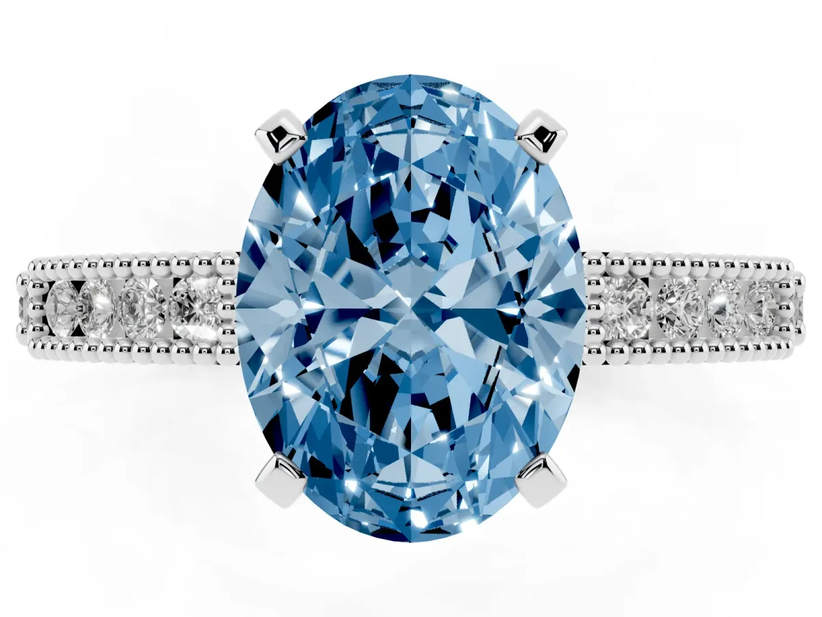 Fancy Blue Oval Cut Solitaire with Pavé Band and Four-Prong Setting Silver