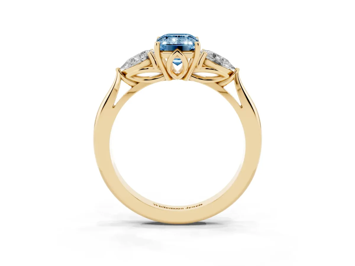Fancy Blue Three-Stone Emerald Cut Brilliant Diamond Solitaire Ring with Tapered Band and Four-Prong Setting Yellow gold