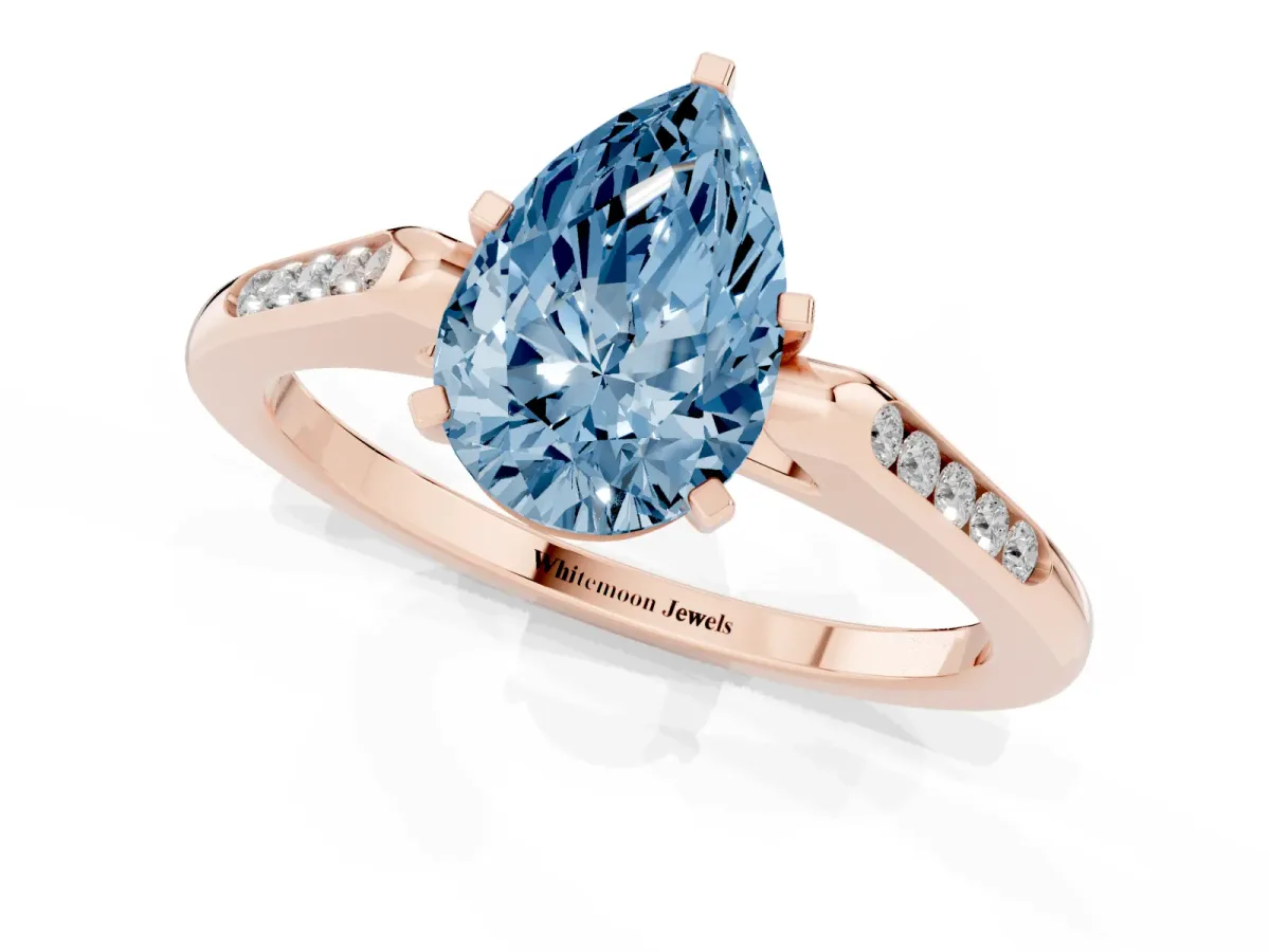 Fancy Blue Pear Cut Diamond Solitaire Ring with Channel Set Round Band and Prong Setting Rose gold