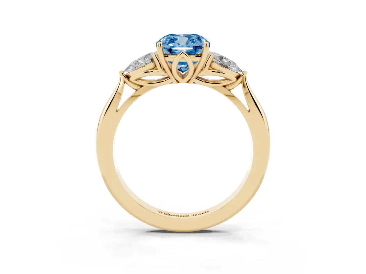 Fancy Blue Three-Stone Cushion Cut Diamond Ring with Pear Side Stones in Four-Prong Setting Yellow gold
