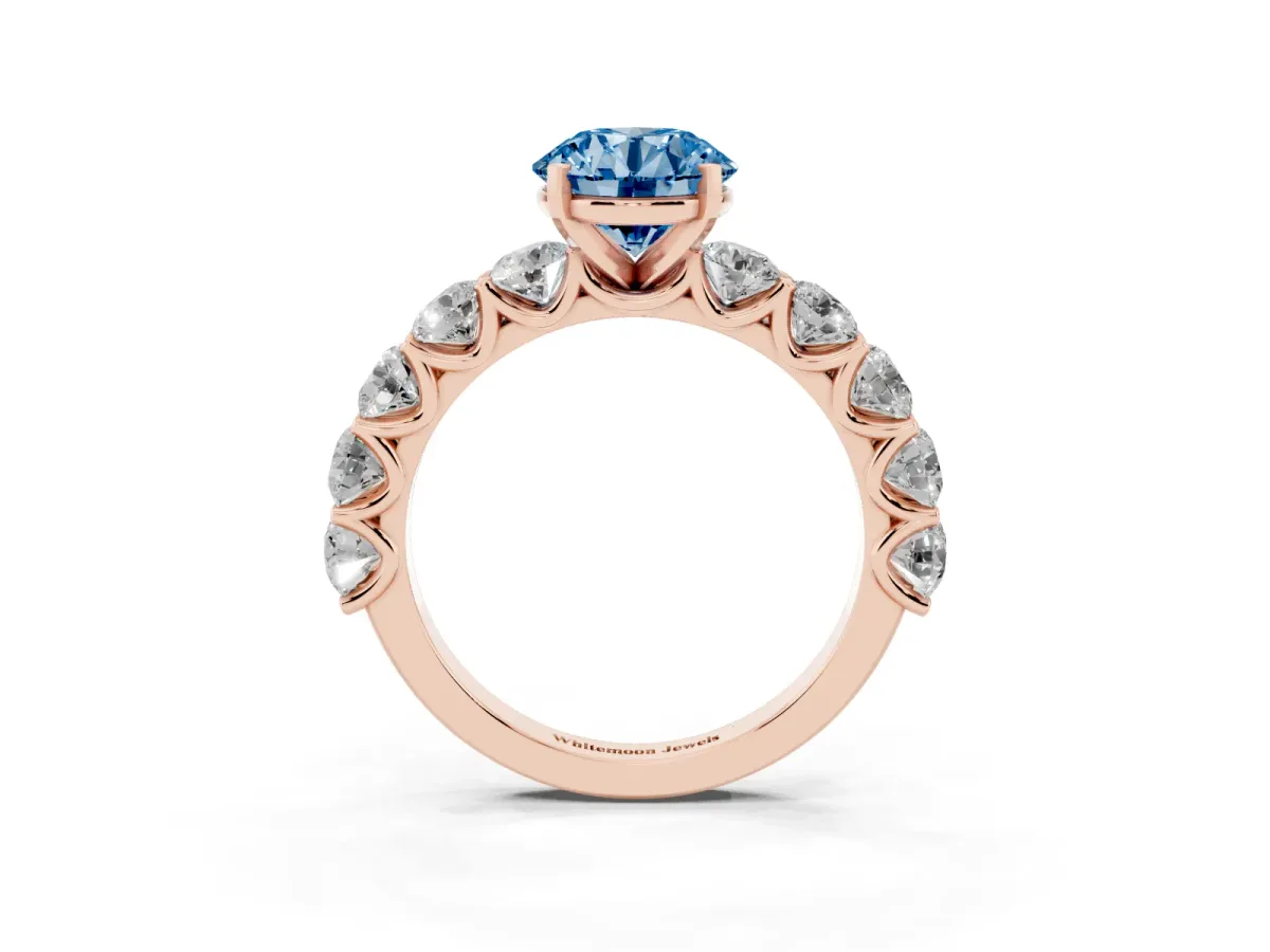 Fancy Blue Round Cut Diamond Prong Setting with Side Stones on a Pave Band Rose gold
