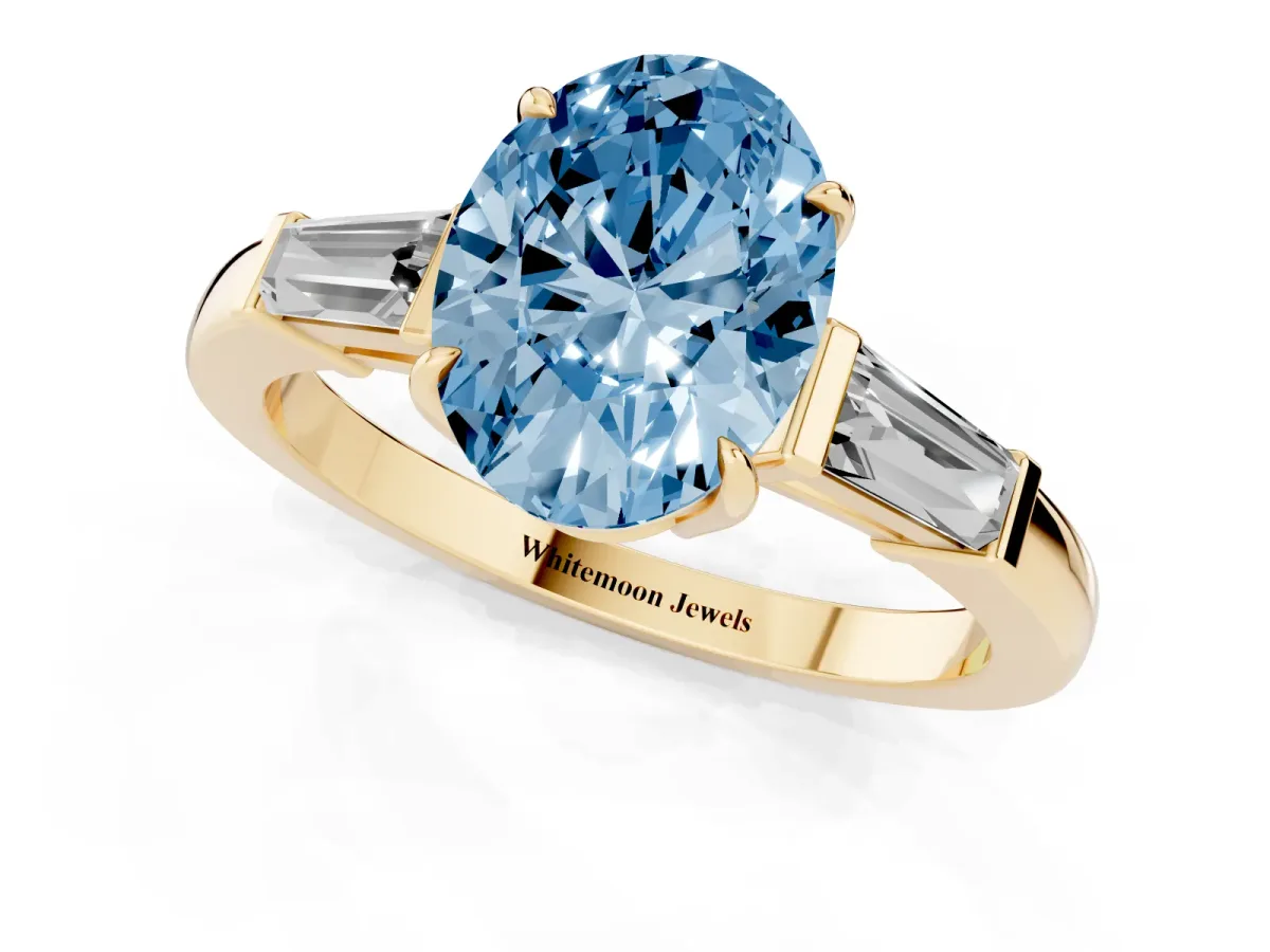 Fancy Blue Oval Cut Diamond Three-Stone Ring with Tapered Baguette Side Stones and Prong Setting Yellow gold