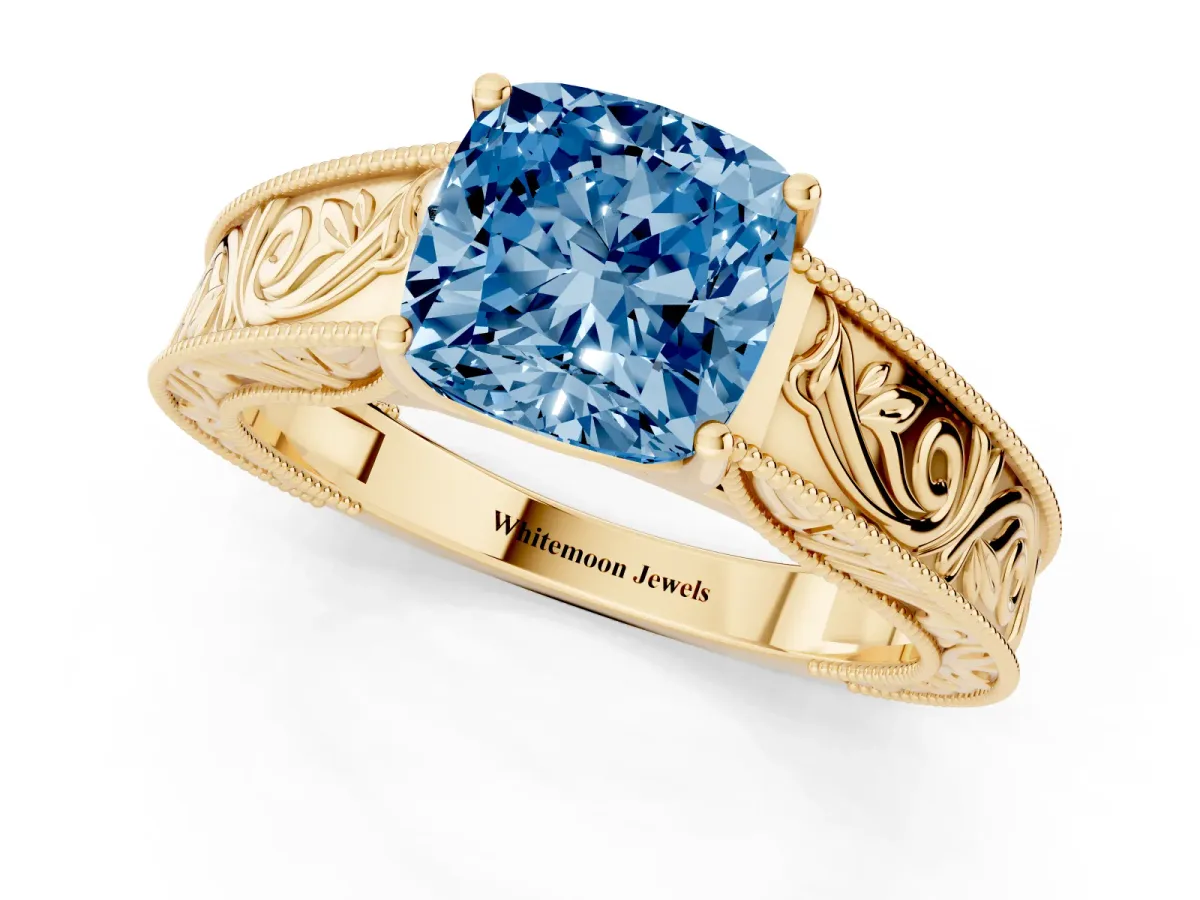 Fancy Blue Cushion Cut Diamond Solitaire Ring with Engraved Band and Four-Prong Setting Yellow gold