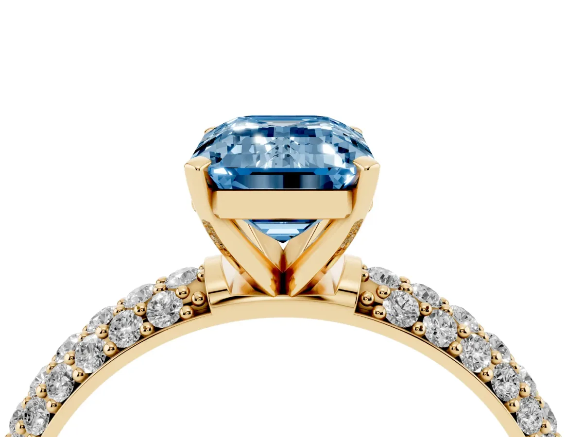 Fancy Blue Emerald Cut Diamond Solitaire Ring with Prong Setting and Pavé Band Yellow gold