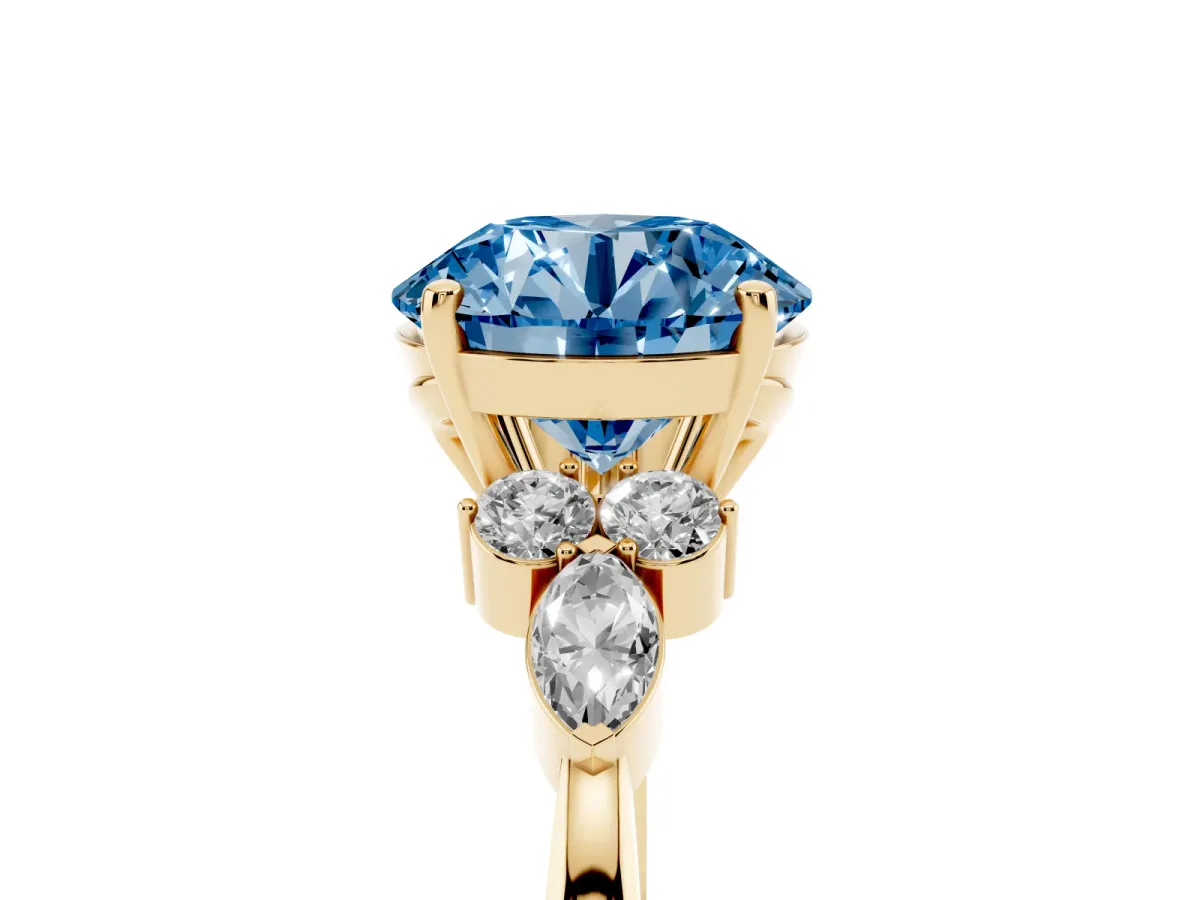 Fancy Blue Round Cut Brilliant Diamond Solitaire Ring with Pear Side Stones and Four-Prong Setting Yellow gold
