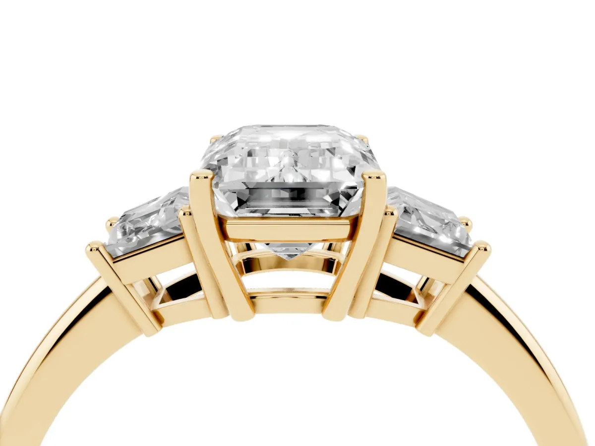 Emerald Cut Diamond Three-Stone Ring with Trapezoid Side Stones and Prong Setting Yellow gold