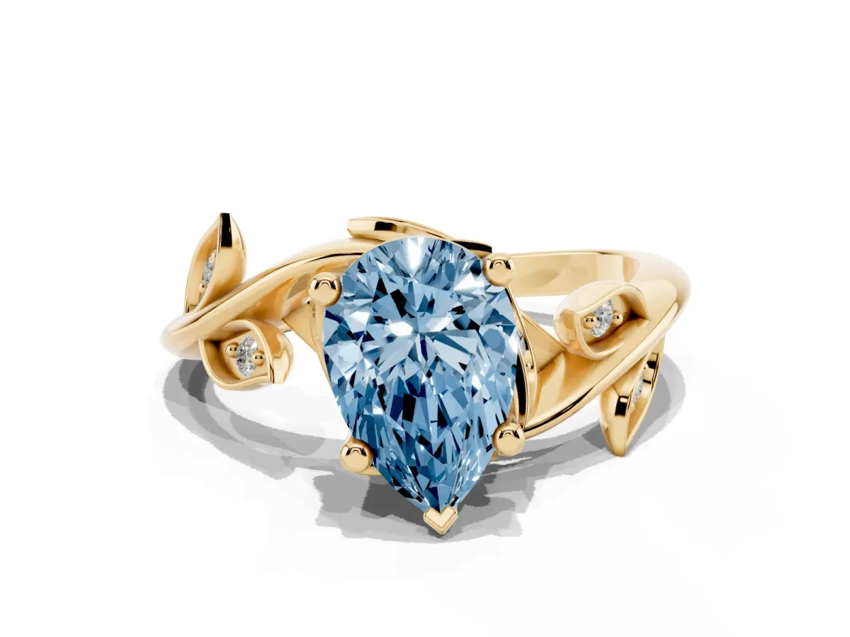 Fancy Blue Pear Cut Solitaire Twist Engagement Ring with Leaf Accents and Prong Setting Yellow gold