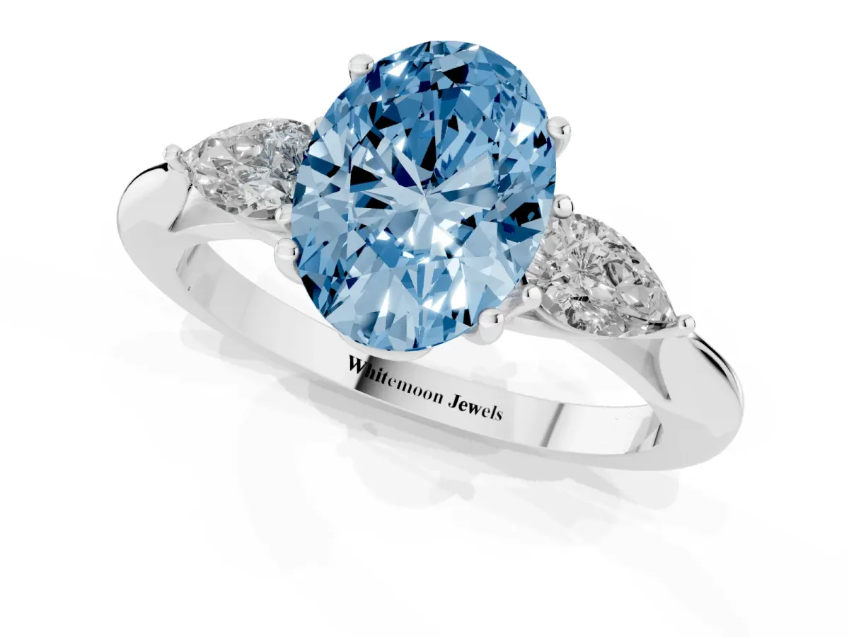 Fancy Blue Three-Stone Oval Cut Diamond Ring with Pear Side Stones in Four-Prong Setting Silver